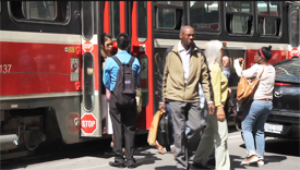 people getting on and off a streetcar